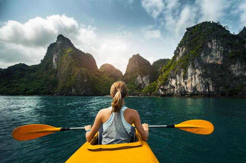 Visitors kayaking to explore Halong Bay